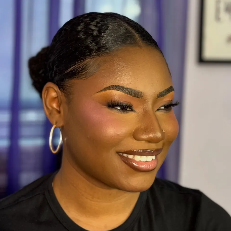 Soft glam makeup with gold hoops, smiling client at the Queens studio
