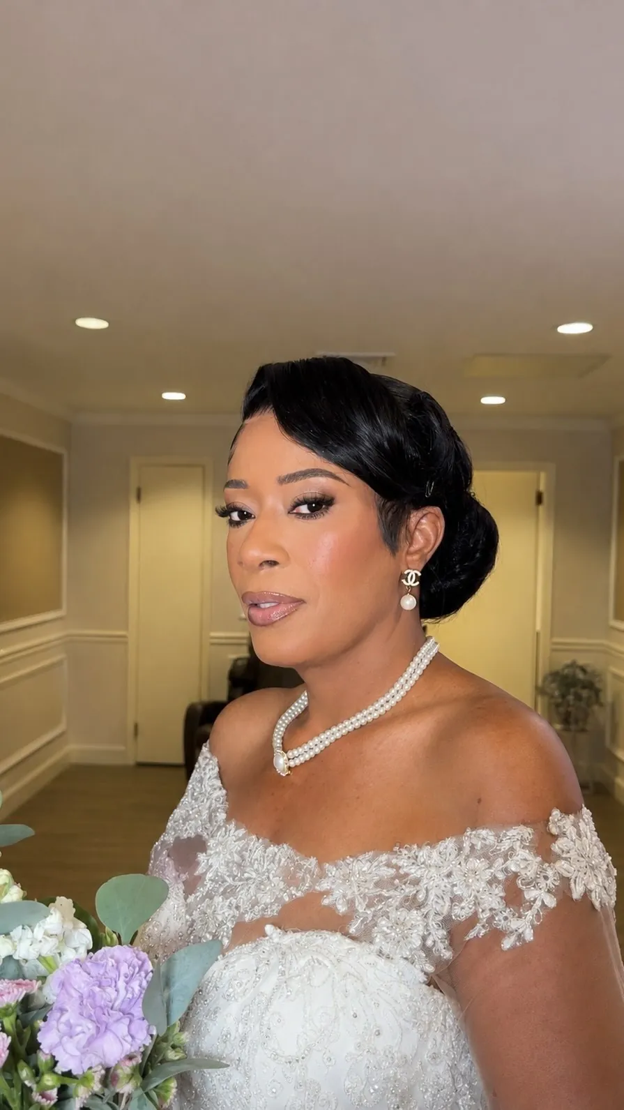 Bridal glam makeup with a lace gown and pearl earrings