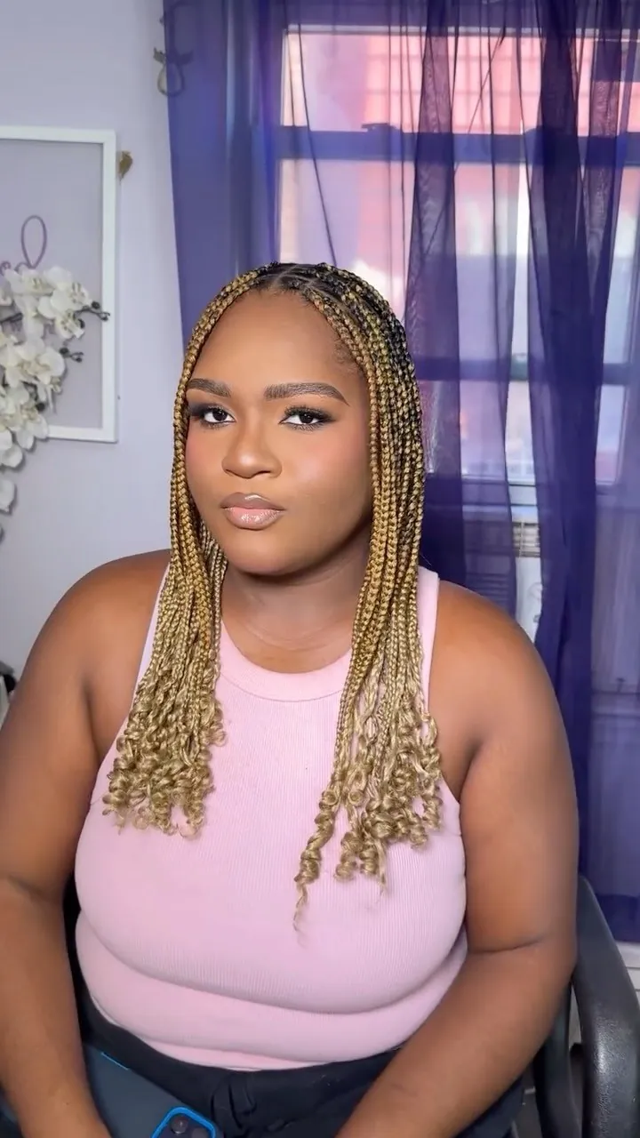Soft glam makeup on a client with blonde knotless braids